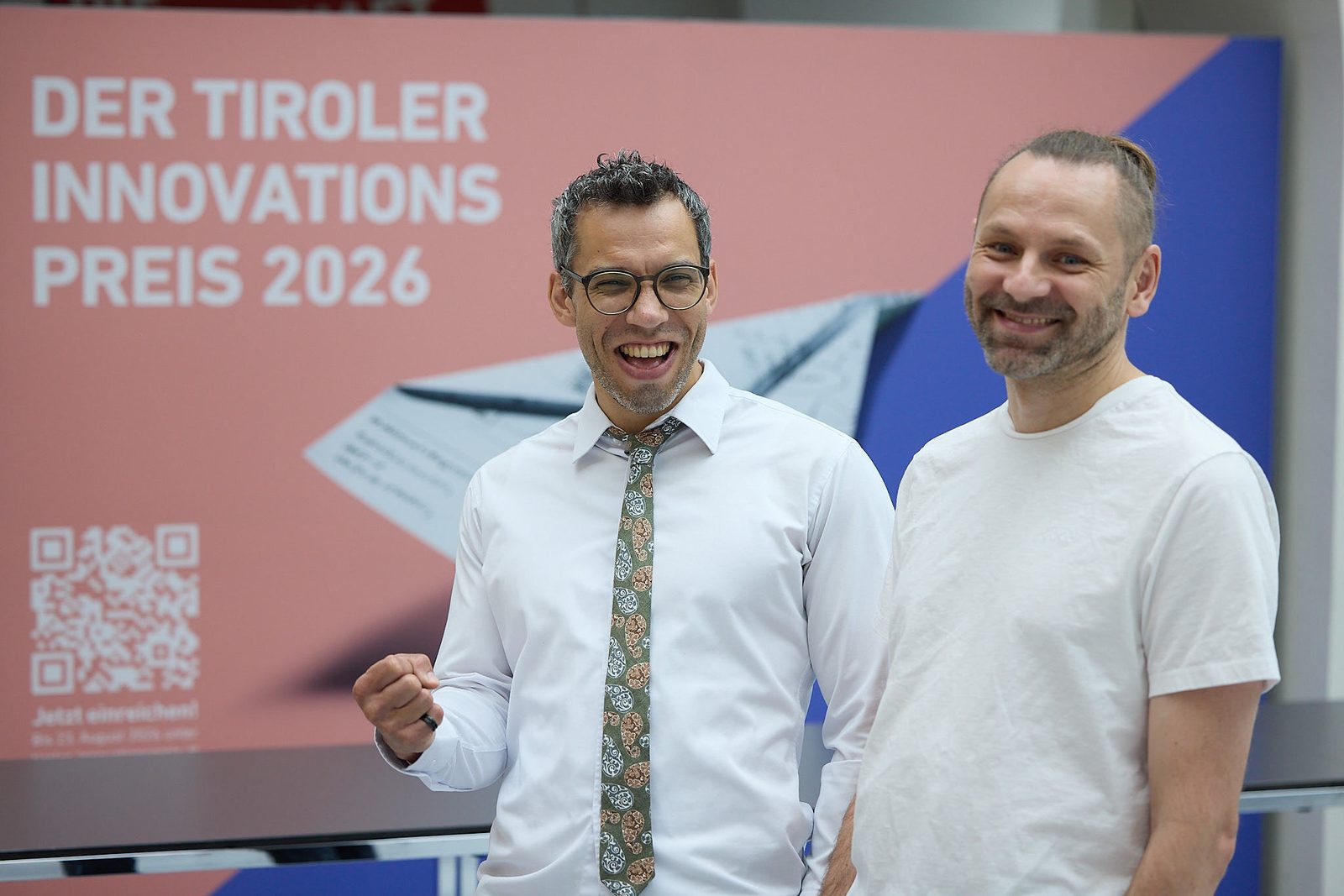 Two Kernity founders in front of the Tyrolean Innovation Award 2026 poster